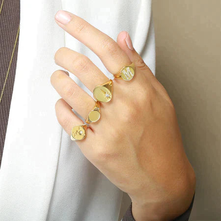 Girl wearing M character ring