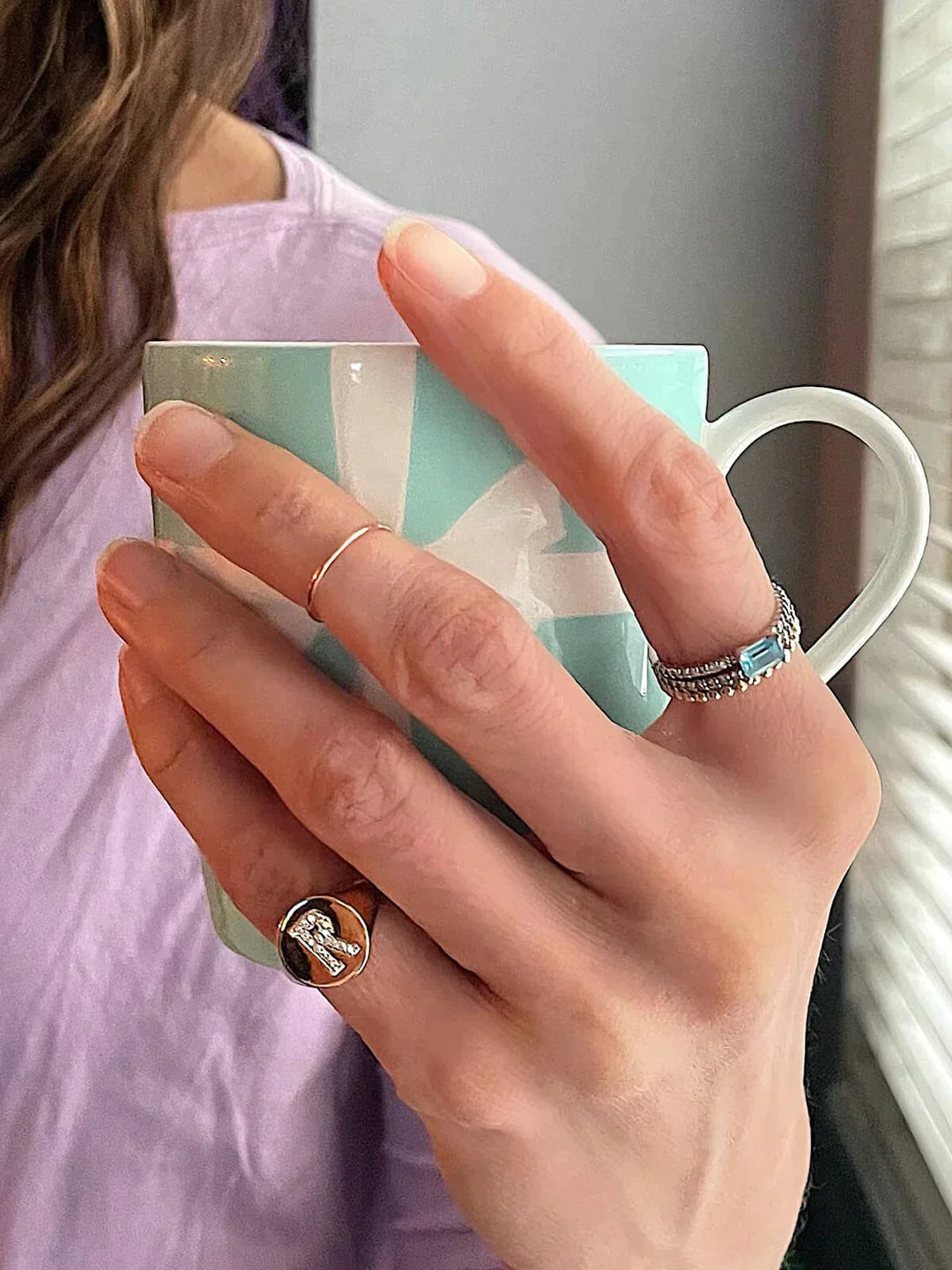 Girl wearing R initial ring