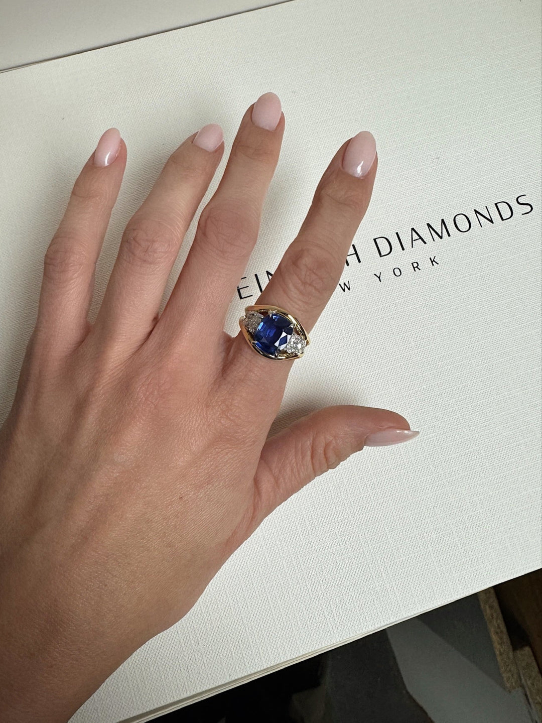 Blue Cushion Sapphire with Oval Diamond Side Stones